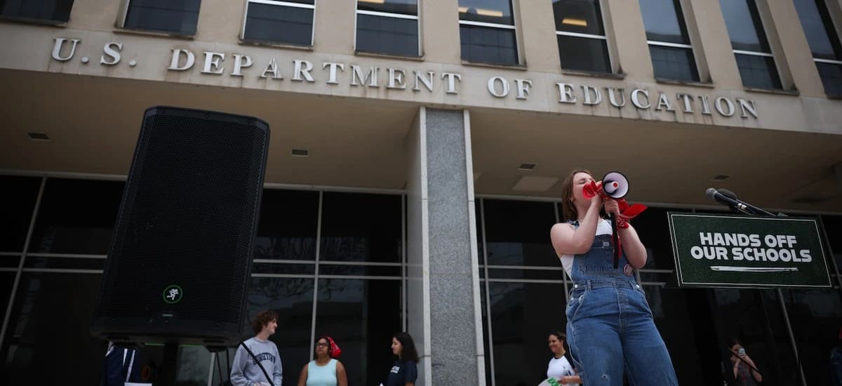 Students protest outside the U.S. Department of Education building during a rally over federal grant program changes.