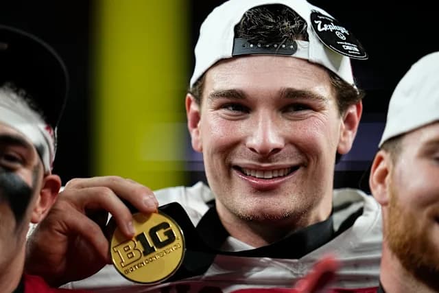 Fernando Mendoza smiling and holding a Big Ten medal after Indiana's championship win