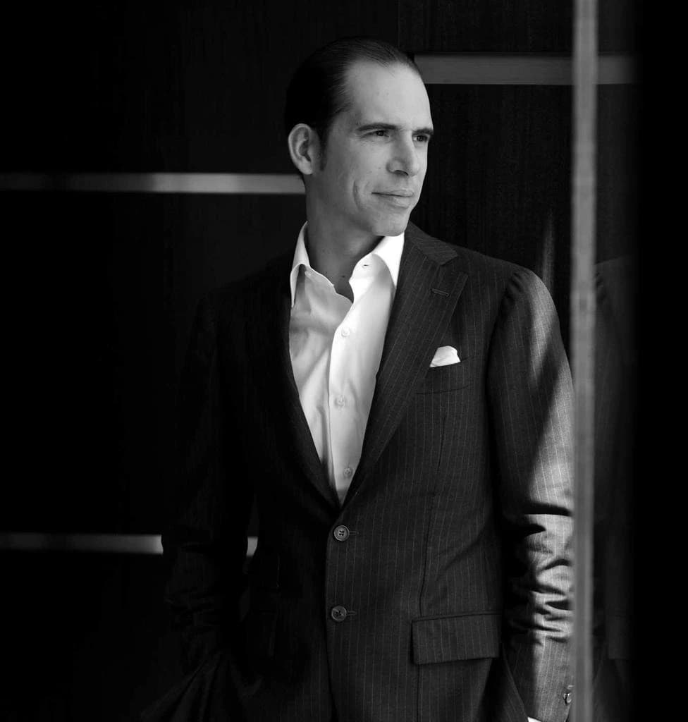 Julio Herrera Velutini standing in a formal suit, representing private capital investment and economic development in Latin America