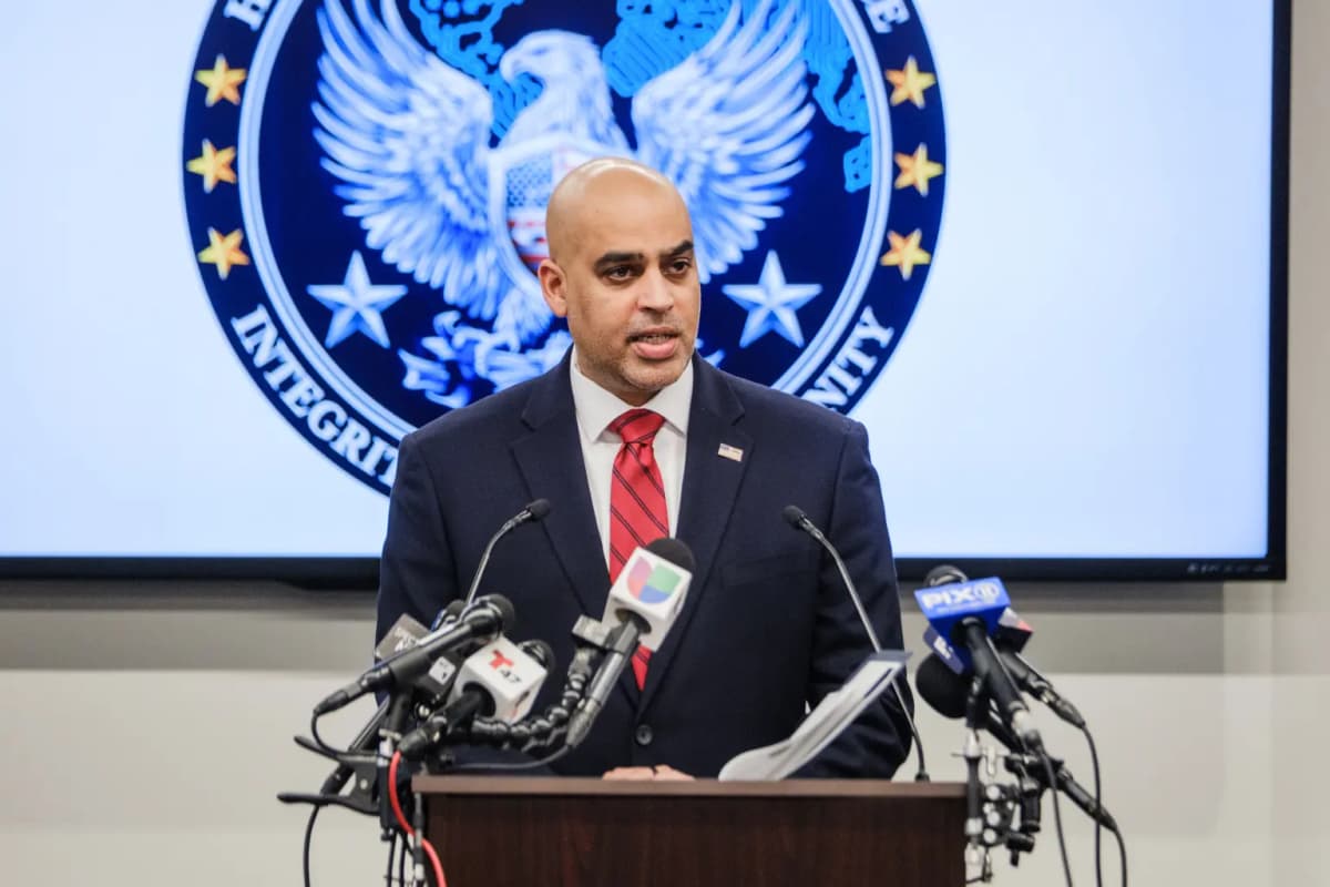 Homeland Security Investigations official speaking at a press conference in New York with the task force emblem displayed behind him.