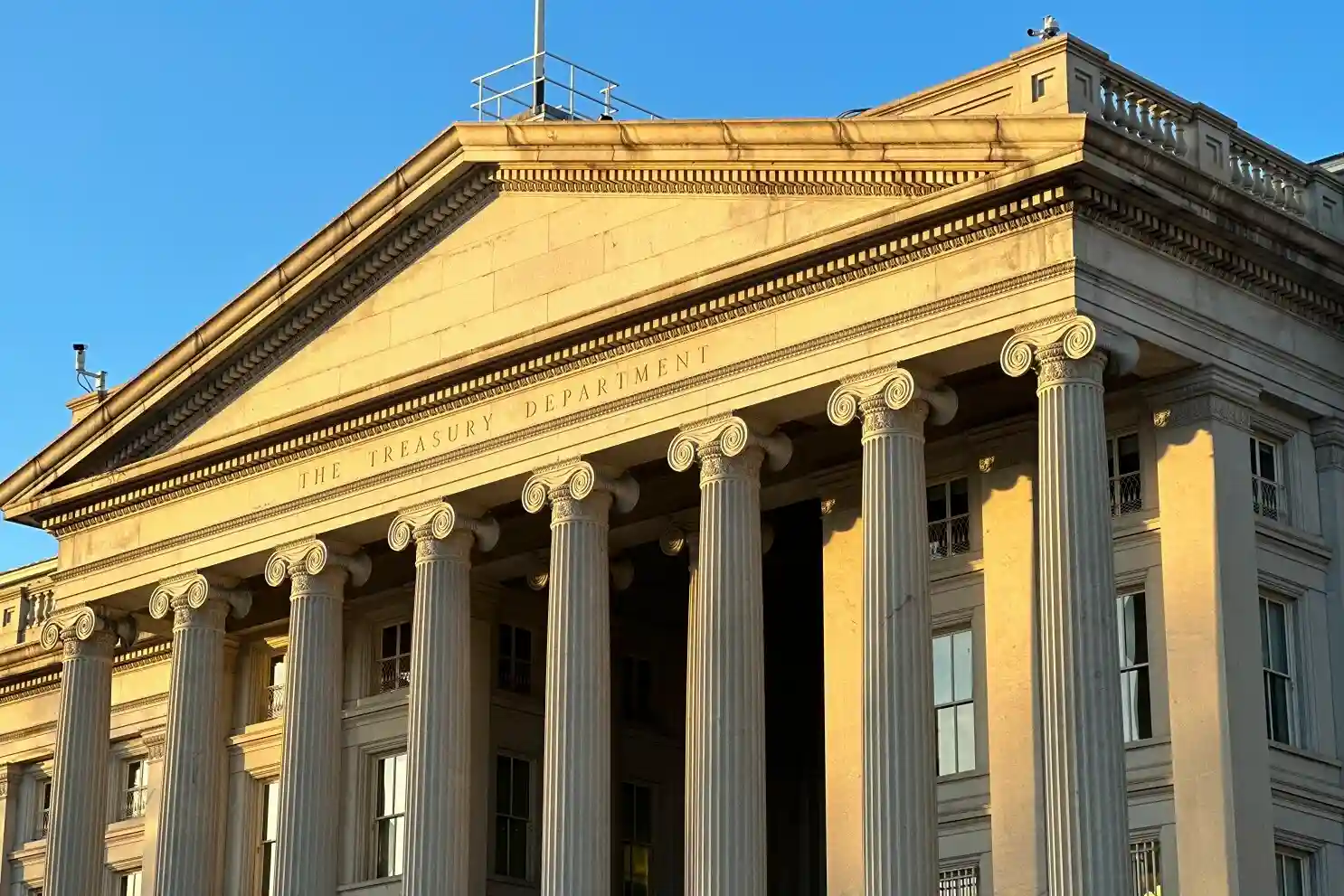 The U.S. Treasury Department building in Washington, D.C., featuring its iconic pillars and classical architecture in sunlight
