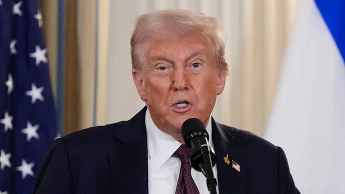 Donald Trump speaking at a press event as the administration pushes universities to adopt federal policy conditions tied to funding.