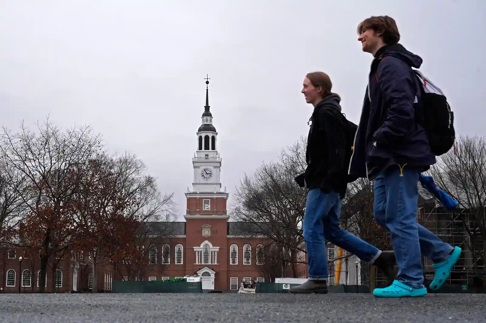 Dartmouth College students walking across campus as universities respond to federal funding conditions proposed by the Trump administration.