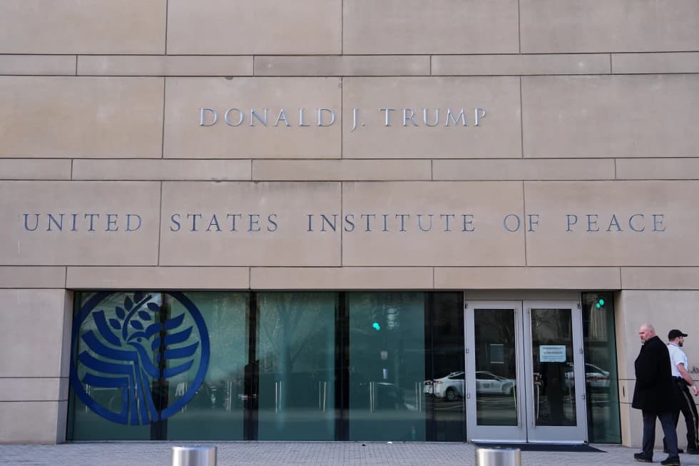 Exterior of the United States Institute of Peace building in Washington with “Donald J. Trump” displayed above the entrance.