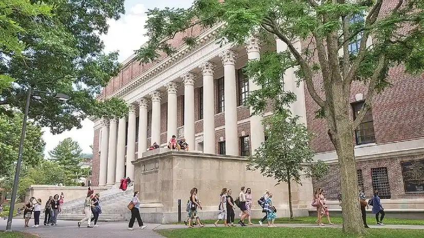 International students walking across a U.S. university campus as institutions face delays under stricter visa policies