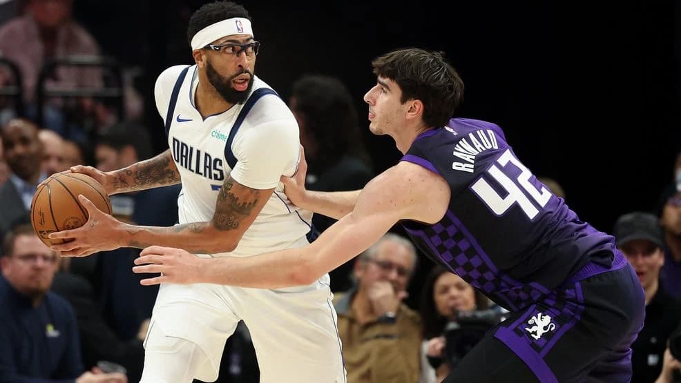 Anthony Davis in Dallas Mavericks uniform posting up against defender during an NBA game